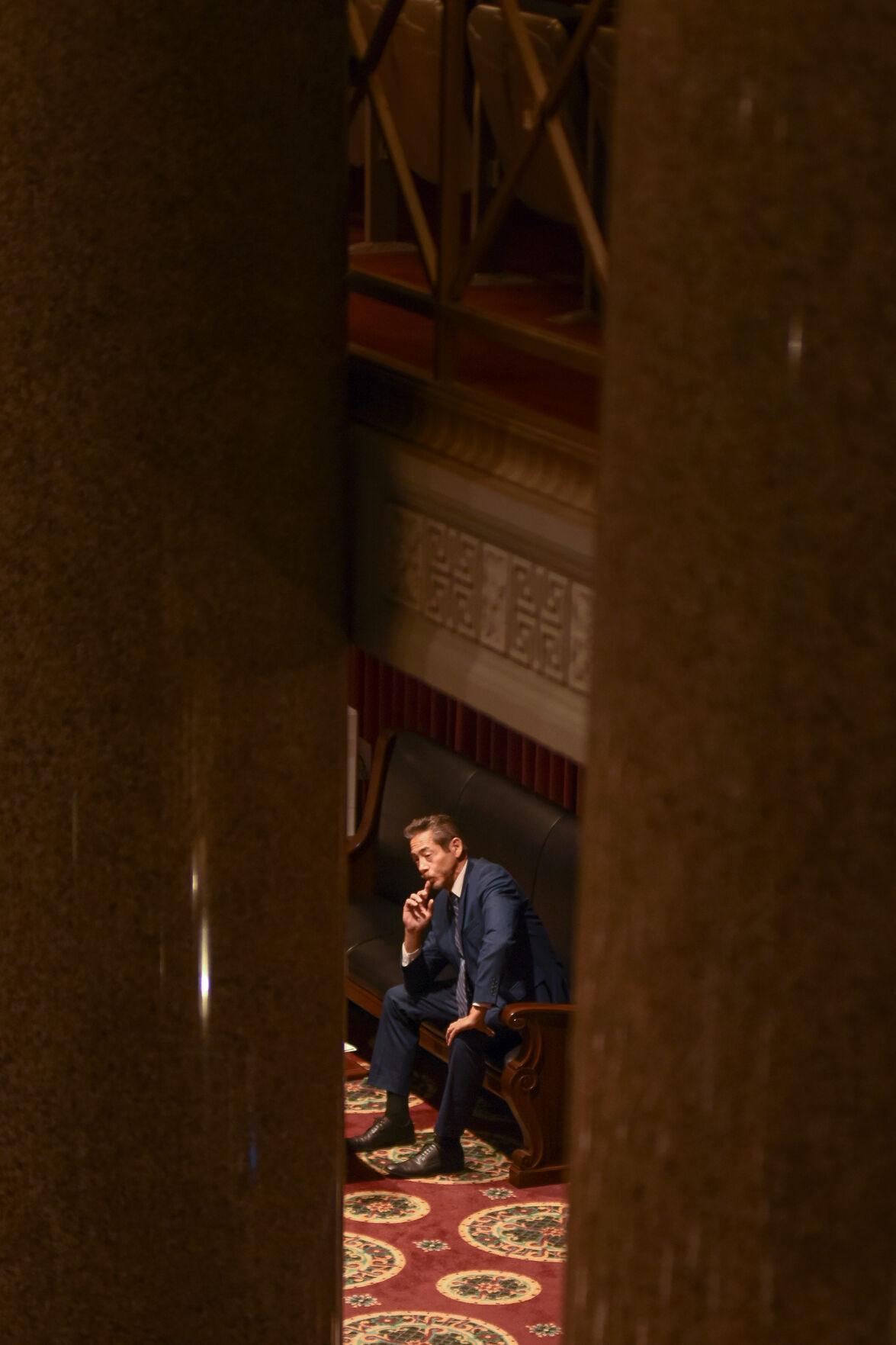 An attendee listens to a hearing